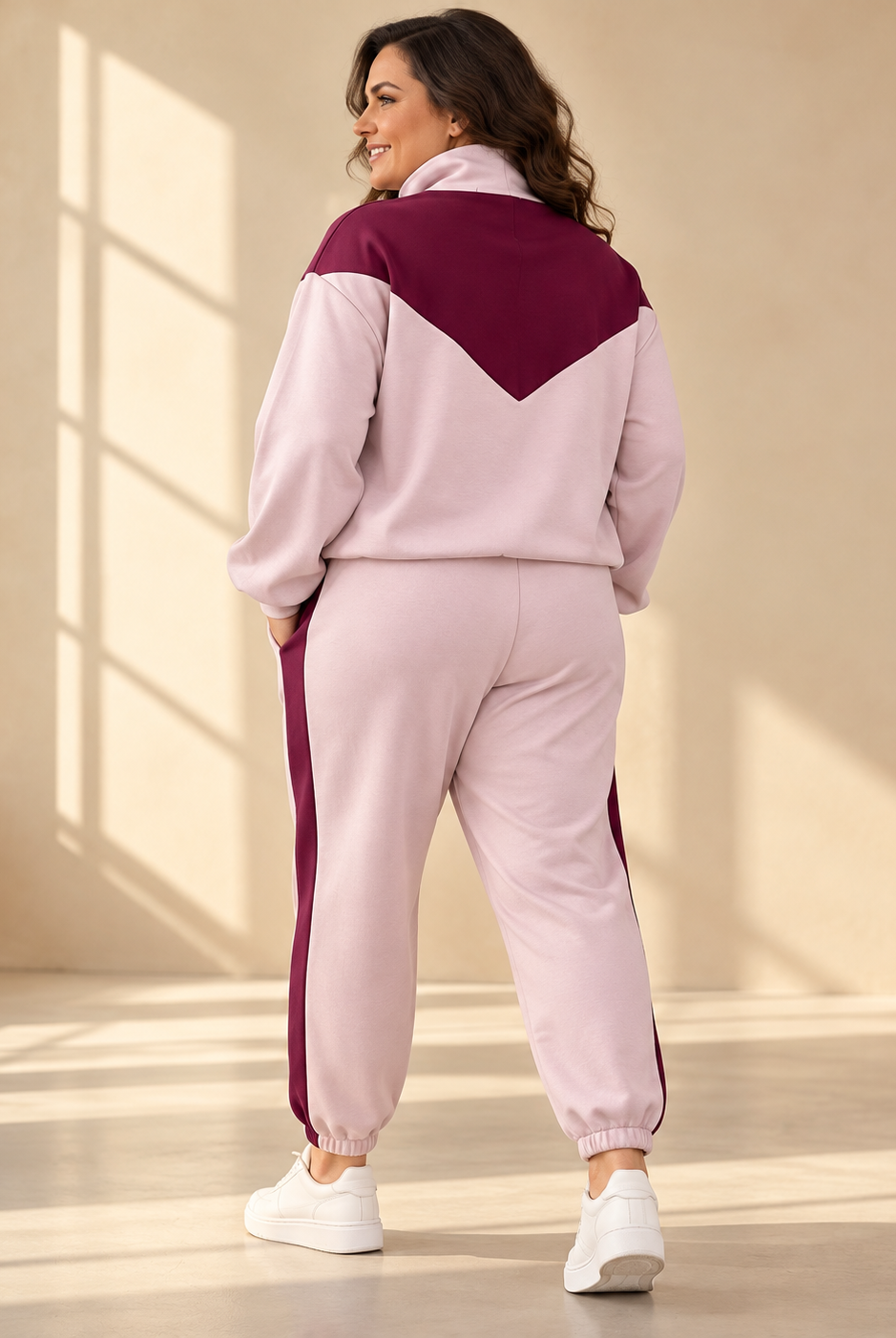 Mira zip jacket in light pink with burgundy V-shaped panel across the chest and shoulders, high collar, front zipper and relaxed fit.