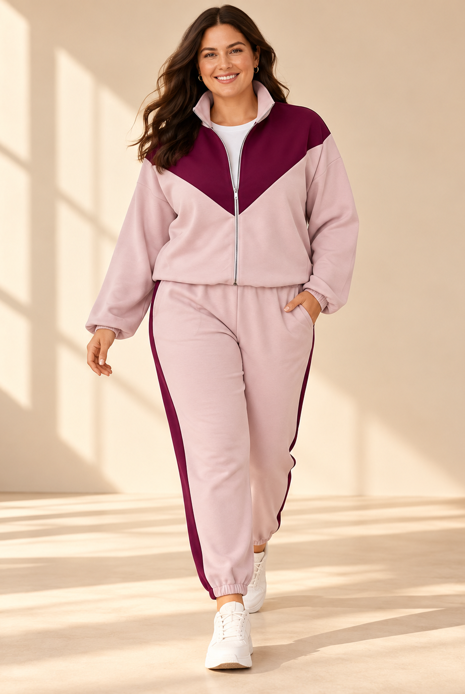 Mira zip jacket in light pink with burgundy V-shaped panel across the chest and shoulders, high collar, front zipper and relaxed fit.