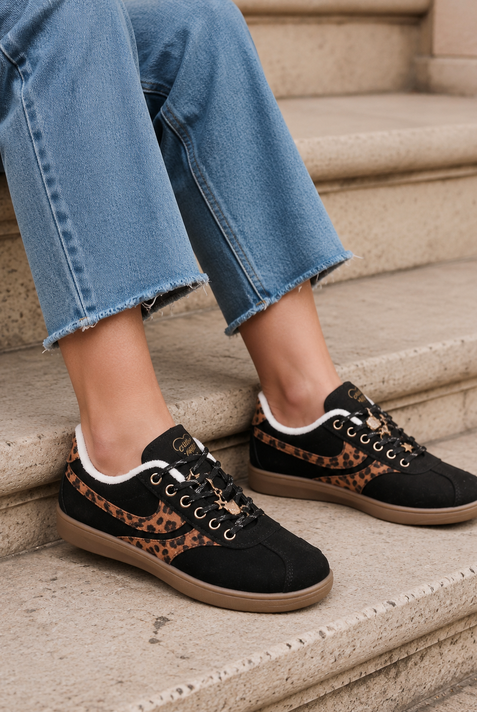 Svarta retro sneakers med leodetaljer stylade med raka jeans