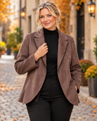 Blazer marron avec surface semblable à du daim, coupe classique, ouvert sur le devant et coupe féminine avec bas légèrement évasé.