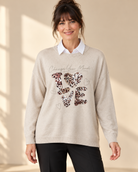 Beige stickad tröja Change LOVE med rund hals, långa ärmar och ledig passform, dekorerad framtill med leopardmönstrat LOVE-motiv och strass.