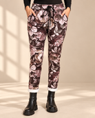 Pantalon de jogging Blomster marron à grandes fleurs dans les tons rose clair et beige, jambes fuselées et extrémités de jambes retroussées