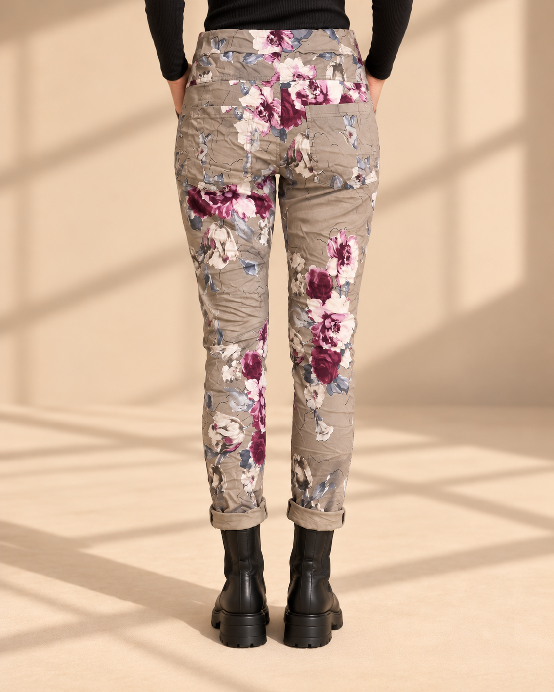Joggers Blomster Fungo med blommönster, elastisk midja, dragsko och sidofickor, visade på modell med uppvikta benslut.