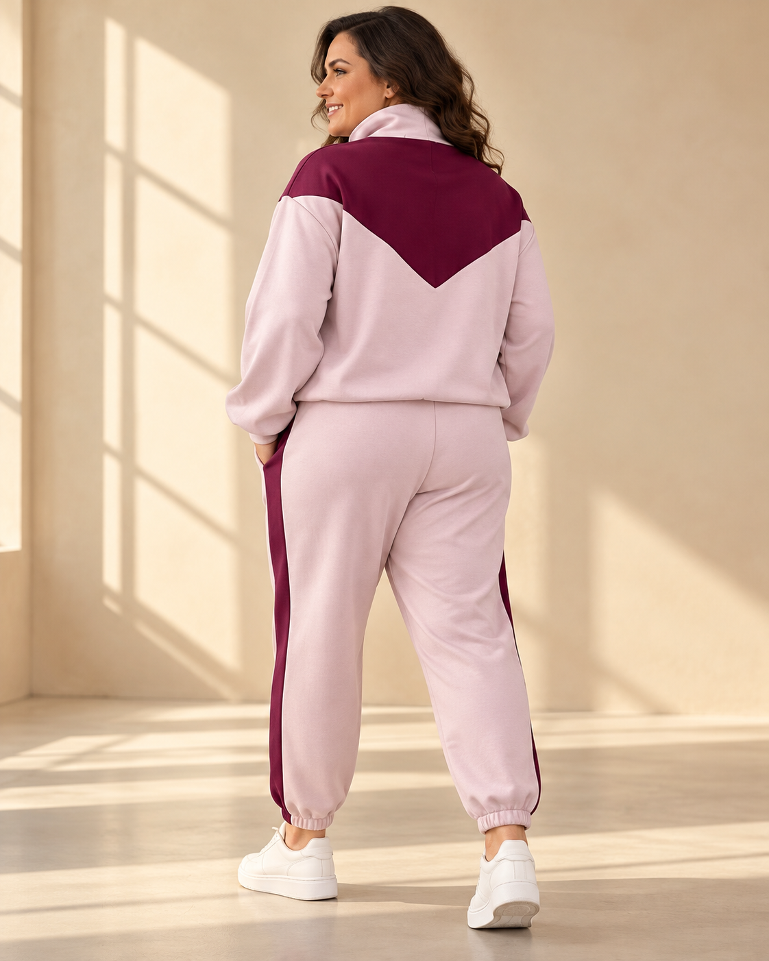 Mira zip jacket in light pink with burgundy V-shaped panel across the chest and shoulders, high collar, front zipper and relaxed fit.